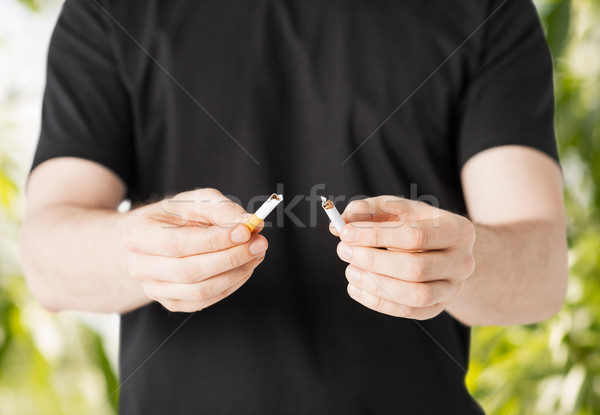 man breaking the cigarette with hands Stock photo © dolgachov