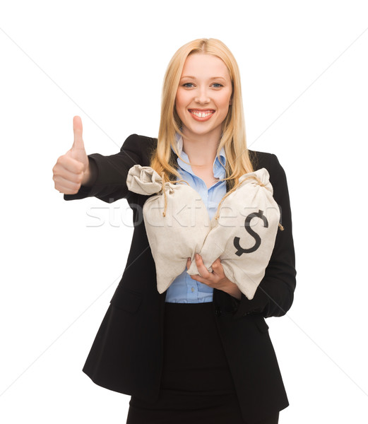 businesswoman with money bags showing thumbs up Stock photo © dolgachov