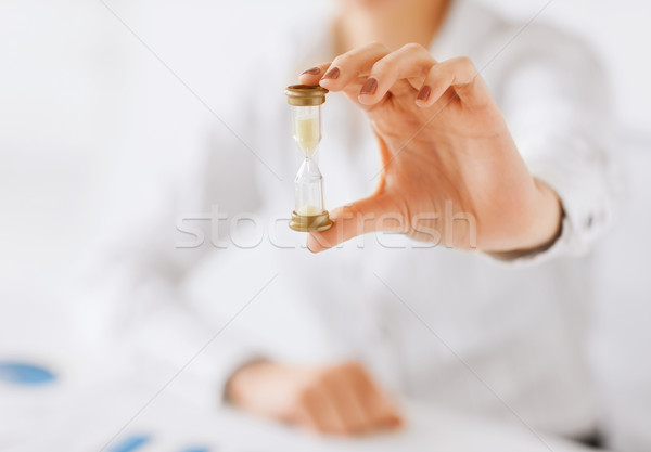 woman hand with sandglass Stock photo © dolgachov