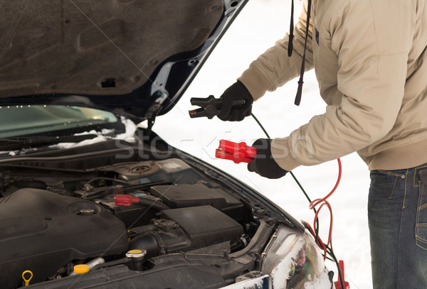 closeup of man under bonnet with starter cables Stock photo © dolgachov