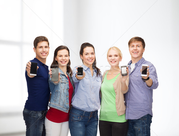 students showing blank smartphones screens Stock photo © dolgachov