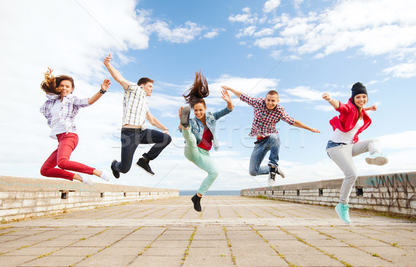 group of teenagers jumping Stock photo © dolgachov