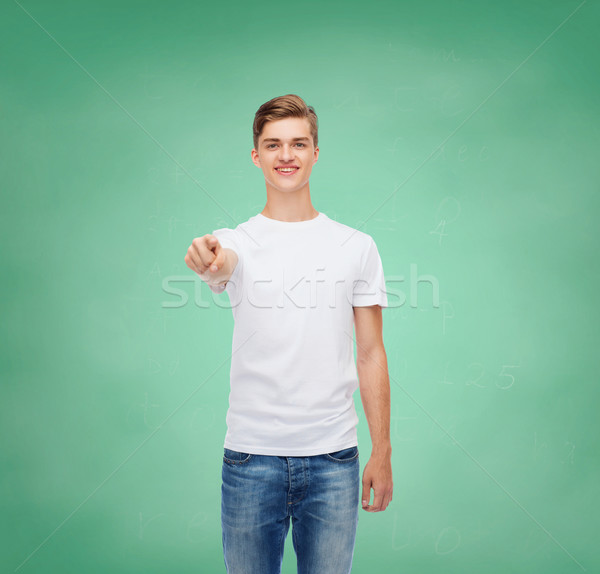 笑みを浮かべて 若い男 白 Tシャツ ジェスチャー 広告 ストックフォト © dolgachov