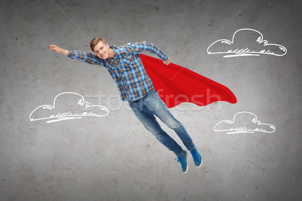 smiling young man jumping in air Stock photo © dolgachov