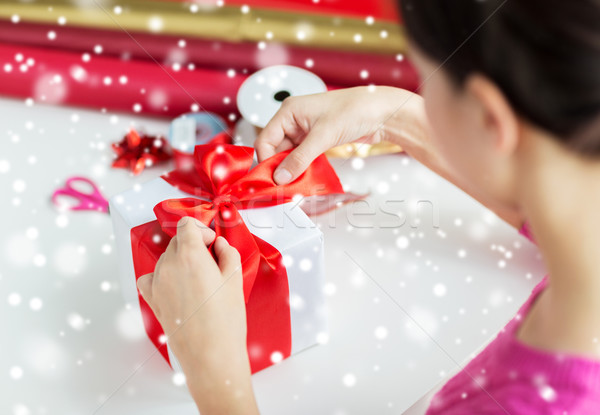 close up of woman decorating christmas present Stock photo © dolgachov