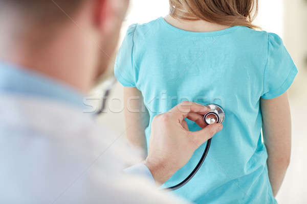 close up of girl and doctor on medical exam Stock photo © dolgachov