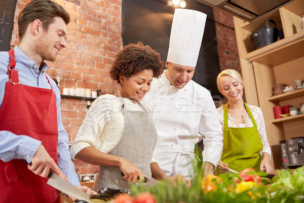 happy friends and chef cook cooking in kitchen Stock photo © dolgachov