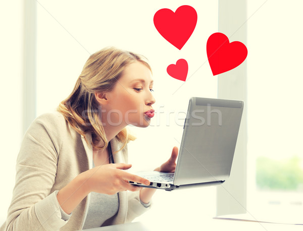 woman sending kisses with laptop computer Stock photo © dolgachov
