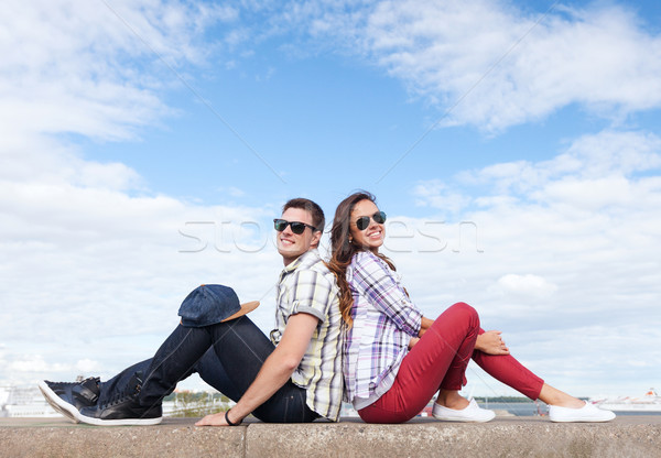 teenagers sitting back to back Stock photo © dolgachov