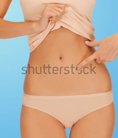 Vrouw wijzend vinger buik Stockfoto © dolgachov