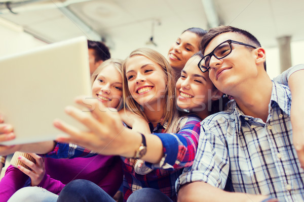 Stock photo: group of smiling students with tablet pc