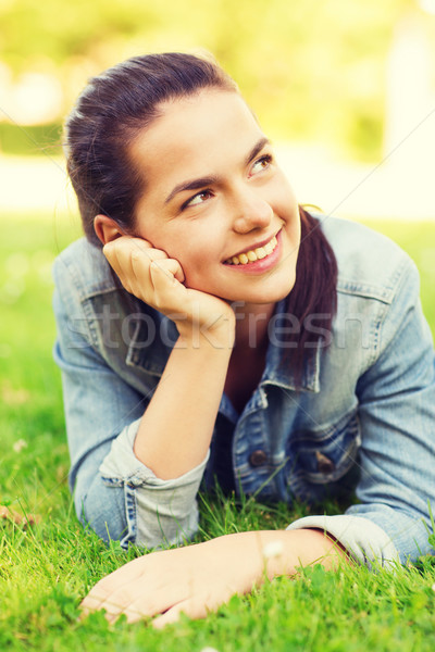 smiling young girl lying on grass Stock photo © dolgachov