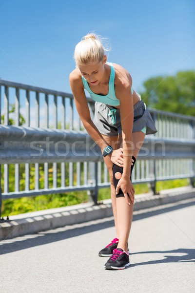 young woman with injured knee or leg outdoors Stock photo © dolgachov