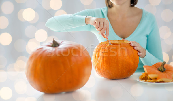 close up of woman carving pumpkins for halloween Stock photo © dolgachov