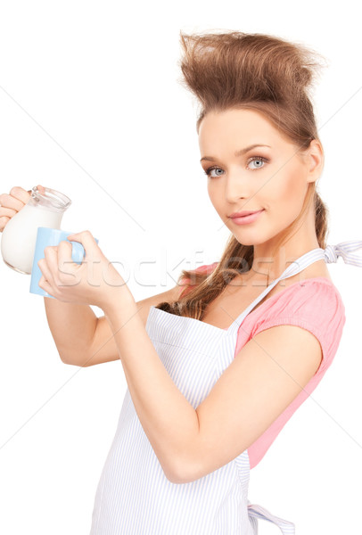 housewife with milk and mug Stock photo © dolgachov