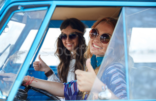 Stock photo: smiling young hippie women driving minivan car