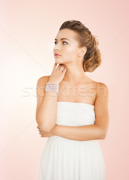 Stock photo: woman with pearl earrings and bracelet