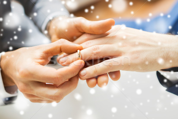 close up of male gay couple hands and wedding ring Stock photo © dolgachov