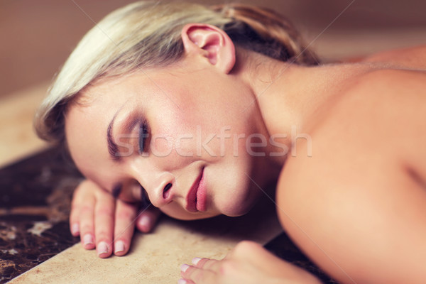 young woman lying on hammam table in turkish bath Stock photo © dolgachov