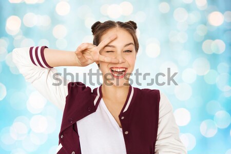 happy smiling teenage girl showing peace sign Stock photo © dolgachov