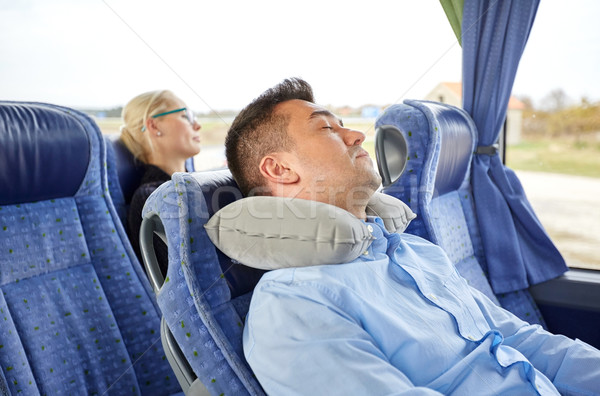 man sleeping in travel bus with cervical pillow Stock photo © dolgachov