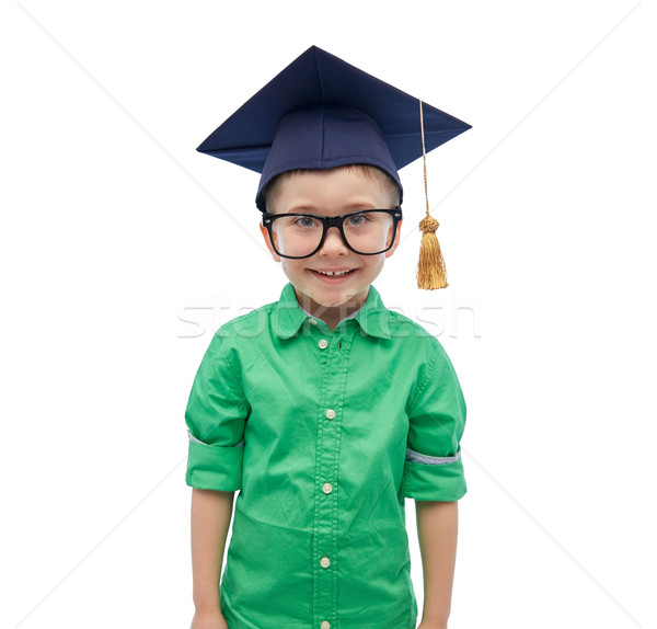 happy boy in bachelor hat or mortarboard Stock photo © dolgachov
