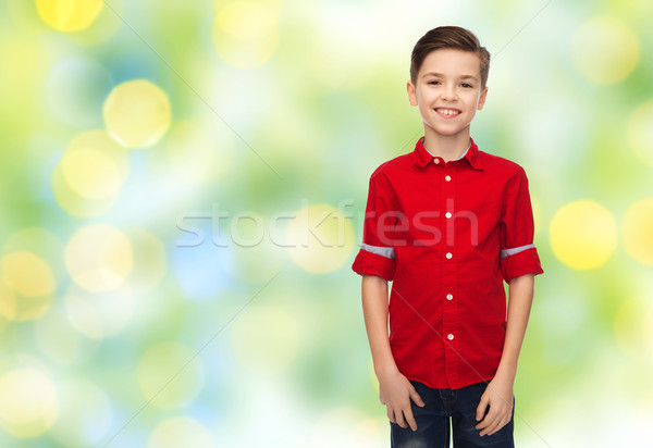 happy boy in red shirt over green lights Stock photo © dolgachov