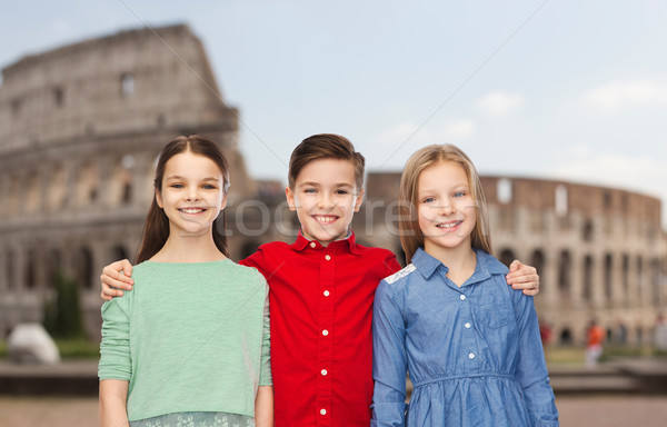 happy boy and girls hugging over coliseum in rome Stock photo © dolgachov