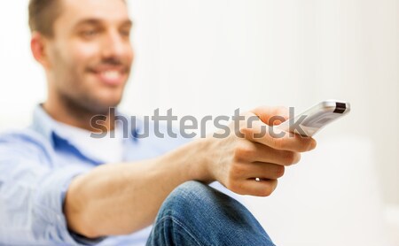 close up of man with tv remote control at home Stock photo © dolgachov