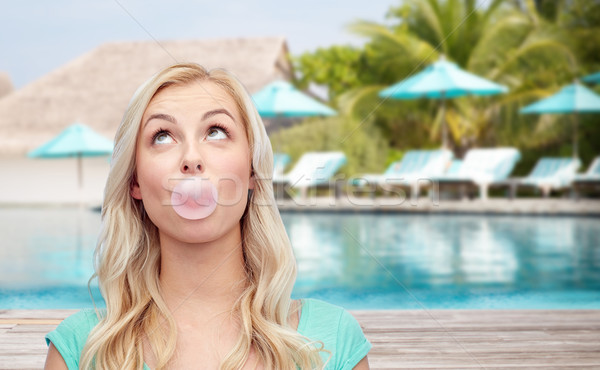 happy woman or teenage girl chewing gum on beach Stock photo © dolgachov
