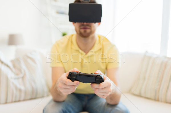 close up of man in virtual reality headset playing Stock photo © dolgachov