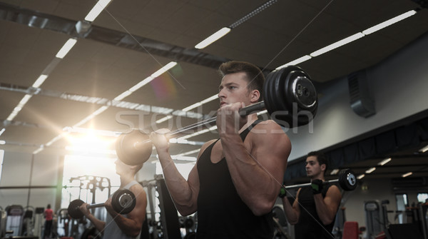 Gruppe Männer Muskeln Langhantel Fitnessstudio Sport Stock foto © dolgachov