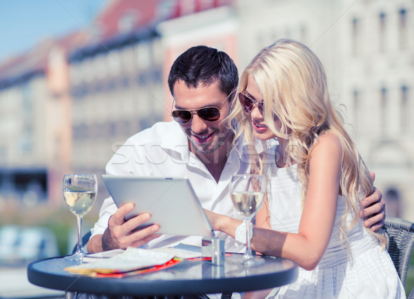 couple looking at tablet pc in cafe Stock photo © dolgachov