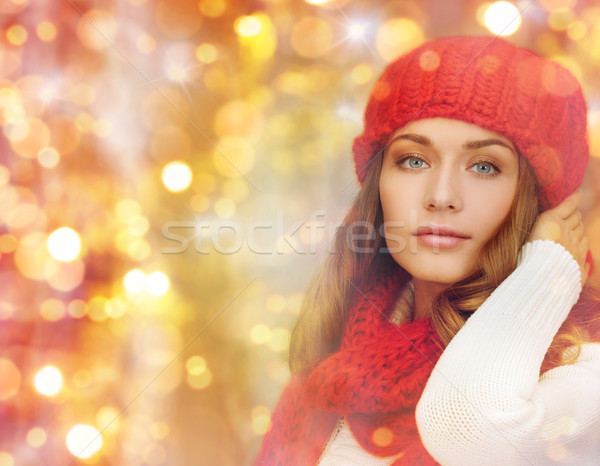 happy woman in hat, scarf and pullover over lights Stock photo © dolgachov