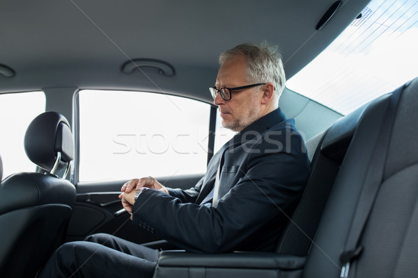 senior businessman driving on car back seat Stock photo © dolgachov
