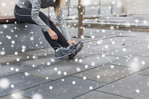 close up of sporty woman tying shoes outdoors Stock photo © dolgachov