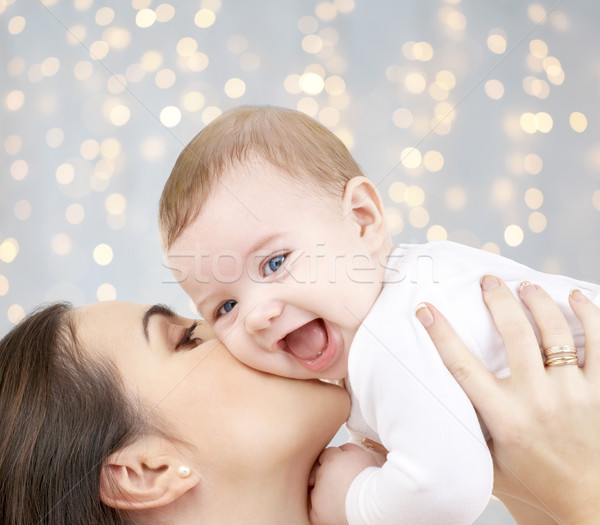 happy mother kissing adorable baby Stock photo © dolgachov