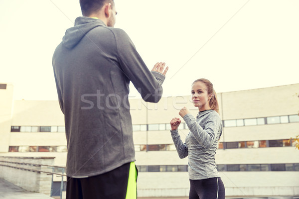 Stock photo: woman with trainer working out self defense strike