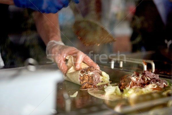 cook cooking tortilla wraps at street market Stock photo © dolgachov