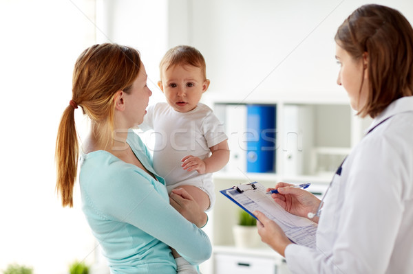 happy woman with baby and doctor at clinic Stock photo © dolgachov