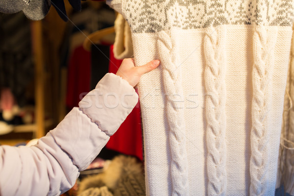 woman buying woolen clothes at christmas market Stock photo © dolgachov