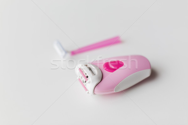 epilator and safety razor on white background Stock photo © dolgachov