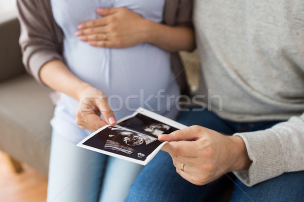 close up of couple with baby ultrasound images Stock photo © dolgachov