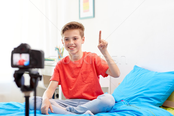 happy boy with camera recording video at home Stock photo © dolgachov