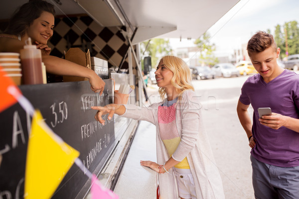 happy customers queue at food truck Stock photo © dolgachov