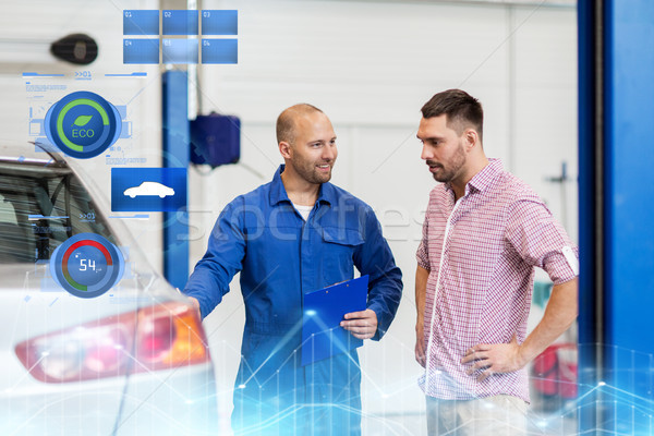 Stock photo: auto mechanic with clipboard and man at car shop