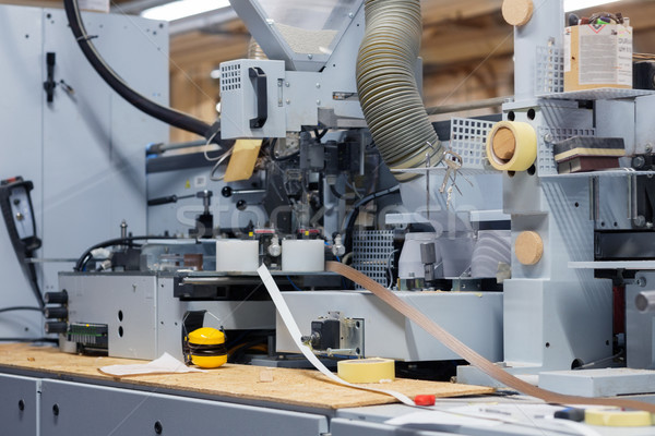 Stock photo: veneer or edge banding machine at factory