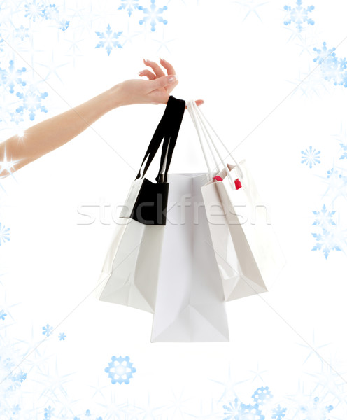 Kéz bevásárlótáskák hópelyhek három divat tél Stock fotó © dolgachov