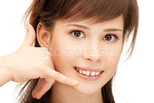 teenage girl making a call me gesture Stock photo © dolgachov