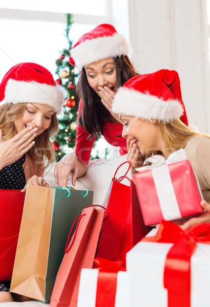 women in santa helper hats with shopping bags Stock photo © dolgachov